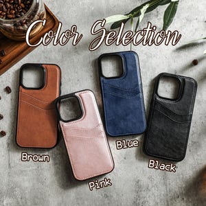 May include: Four phone cases in different colors: brown, pink, blue, and black. The cases have a wallet-style design with a flap that covers the camera lens. The text "Color Selection" is at the top of the image.