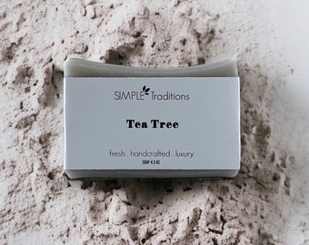May include: A bar of gray soap with the text "SIMPLE Traditions Tea Tree fresh. handcrafted. luxury SOAP 4.5 OZ" on the label.