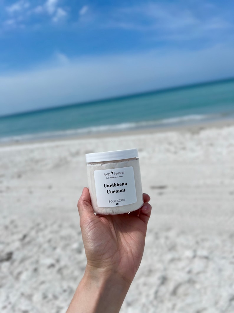 May include: A white jar of Caribbean Coconut body scrub with a white label that says "Simple Traditions" and "Caribbean Coconut Body Scrub".