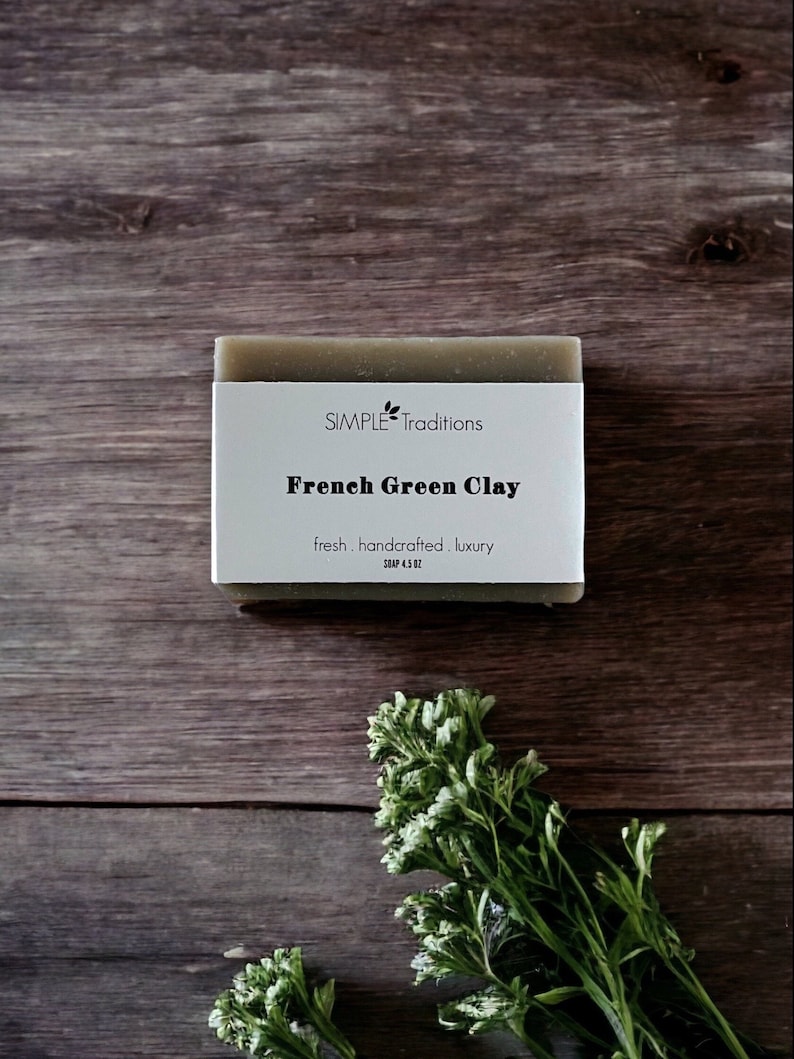 May include: A bar of green soap with the text "SIMPLE Traditions French Green Clay fresh handcrafted luxury SOAP 4.5 OZ" on a white label.