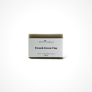 May include: A bar of green French Green Clay soap from Simple Traditions. The soap is labeled "fresh, handcrafted, luxury".