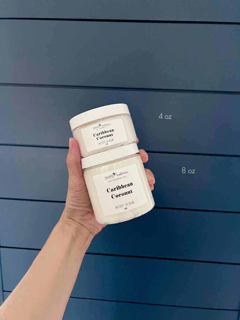 May include: Two white jars of body scrub with the text "Simple Traditions" and "Caribbean Coconut" on the labels. The smaller jar is 4 oz and the larger jar is 8 oz.