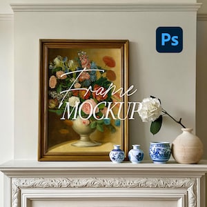 May include: A rectangular gold-toned frame containing a floral still life painting of a bouquet in a pedestal vase. The frame sits on a mantelpiece alongside two small blue and white patterned vases, a larger blue and white bowl, and a beige vase.