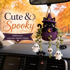 May include: A crocheted rearview mirror charm featuring a black cat wearing a purple witch hat, sitting in a purple pot with green vines. The charm includes dangling crocheted figures of two white ghosts, two black spiders, and one beige skull.