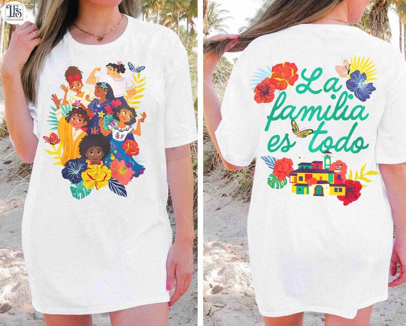 May include: White t-shirt featuring a colorful illustration of animated characters surrounded by flowers and butterflies. The back of the shirt has the text "La familia es todo" with a butterfly and floral accents. A casual, comfortable style.