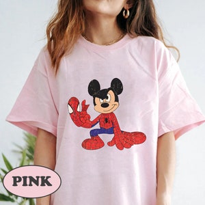 May include: Pink t-shirt with a cartoon image of Mickey Mouse dressed as Spider-Man.