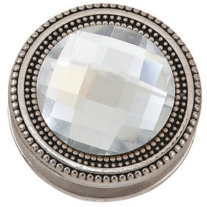 May include: A circular, silver-coloured snap button featuring a clear, faceted central stone. The button has a detailed, beaded border and a raised edge. The design is simple yet elegant, suitable for various craft projects.