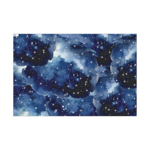 May include: A rectangular fabric with a watercolor design of a night sky. Dark blue clouds and a starry sky are depicted with silver accents. The celestial theme is repeated throughout the pattern.