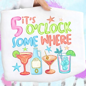 May include: White tote bag featuring the text "It's 5 o'clock somewhere" in bright colours. The design includes cocktail illustrations, a milk bottle, and stars. A fun, whimsical design for a party or celebration.