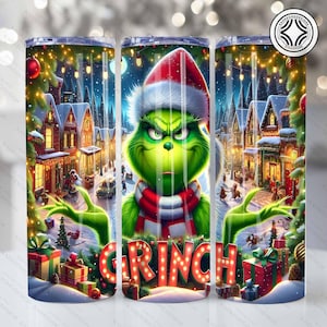 May include: A stainless steel tumbler with a festive Grinch design set in a snowy Christmas village. The Grinch is wearing a Santa hat and scarf, with the word "GRINCH" in red letters. Presents and Christmas trees are also visible.