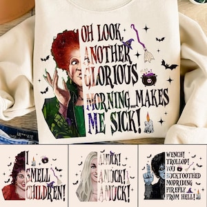 May include: Cream-coloured sweatshirt with a witch graphic and the phrase "OH LOOK, ANOTHER GLORIOUS MORNING...MAKES ME SICK!". The design includes bats, a witch's hat, a broom, and a cauldron, perfect for Halloween.