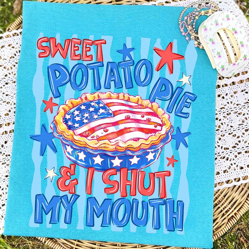 May include: A turquoise blue decorative kitchen towel with the words "Sweet Potato Pie & I Shut My Mouth" in red and blue. The design includes a pie with an American flag design and star accents.