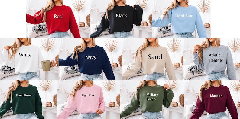 May include: A collection of eleven long-sleeved crewneck sweatshirts shown in various colors including red, black, light blue, white, navy, sand, athletic heather, forest green, light pink, military green, and maroon, each labeled with its color name.