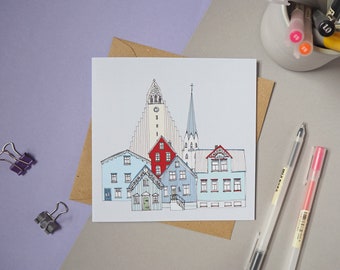 May include: A greeting card with a hand-drawn illustration of a cityscape with a church and several buildings. The buildings are drawn in a simple style with black outlines and colored in with red, blue, and white.