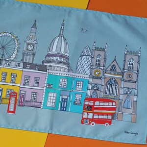 May include: A colorful illustration of London landmarks, including Big Ben, St. Paul's Cathedral, and a red double-decker bus. The illustration is on a light blue background with a yellow border.