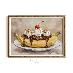 May include: A framed painting of a banana split dessert. The split is in a yellow banana boat, topped with chocolate sauce, whipped cream, a cherry, and nuts. The painting is on a white plate, with a brown and gold frame.