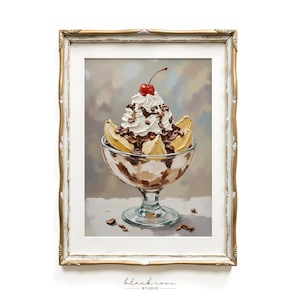May include: A framed print of a banana split dessert. The sundae is in a clear glass bowl and topped with whipped cream, chocolate shavings, a cherry, and banana slices. The frame is gold with ornate detailing. The background is a soft, blurred mix of colors.