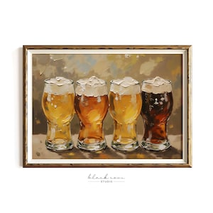 May include: A framed art print featuring four beer glasses with varying shades of amber and brown beer, each topped with a foamy white head. The artwork has a textured, painterly style, with a neutral background and a gold-toned frame. The print is signed "black cove studio".