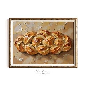 May include: An oil painting of a braided loaf of bread, with a golden crust and a textured, layered appearance. The artwork is set against a neutral, textured background and framed in a gold-toned frame. The artist's signature is at the bottom.