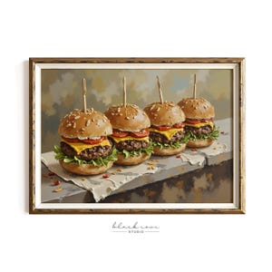May include: A framed print featuring four miniature cheeseburgers. Each burger has a sesame seed bun, a beef patty, cheese, tomato, and lettuce, secured with a wooden skewer. The burgers rest on a white paper, with a neutral background.