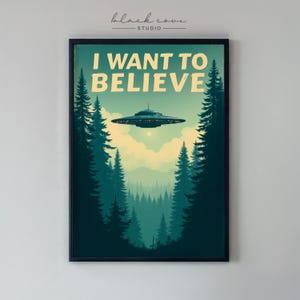 May include: Framed art print featuring a retro-style illustration of a UFO hovering over a forest. The text "I WANT TO BELIEVE" is displayed in a vintage font. The artwork is set against a backdrop of green and blue trees.