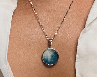 Ocean Reach Pendant – One-of-a-Kind Resin Necklace in Bright Blue with White Wave Tendrils | Silver Circular Frame