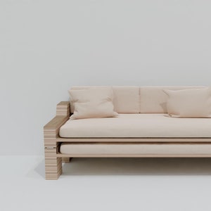 May include: A light wood frame sofa with a light beige fabric cushion and two pillows. The sofa is on a white background.