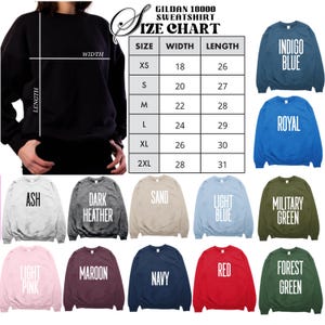 May include: A black sweatshirt with a size chart and color options. The size chart shows measurements in inches. Color options include indigo blue, royal, ash, dark heather, sand, light blue, military green, light pink, maroon, navy, red, and forest green.
