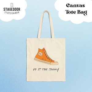 May include: Cream-colored canvas tote bag with a large orange high-top sneaker graphic. The text "DO IT FOR JOHNNY" is printed below the shoe. The words "Canvas Tote Bag" are at the top.