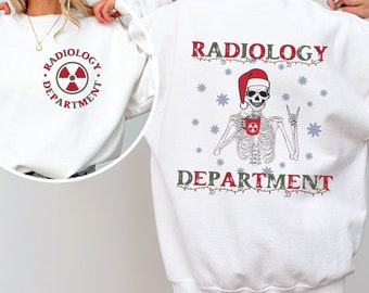 May include: White sweatshirt with a Christmas-themed radiology department design. The front features a red and white radiation symbol with the text "Radiology Department". The back features a skeleton holding a mug with the text "Radiology Department" and Christmas lights.