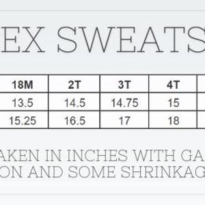 May include: A white graphic with the text "UNISEX SWEATSHIRT" and a size chart. The chart lists chest width and length measurements in inches for sizes 12M to 8. The text at the bottom states measurements are in inches and the garment is 100% cotton.