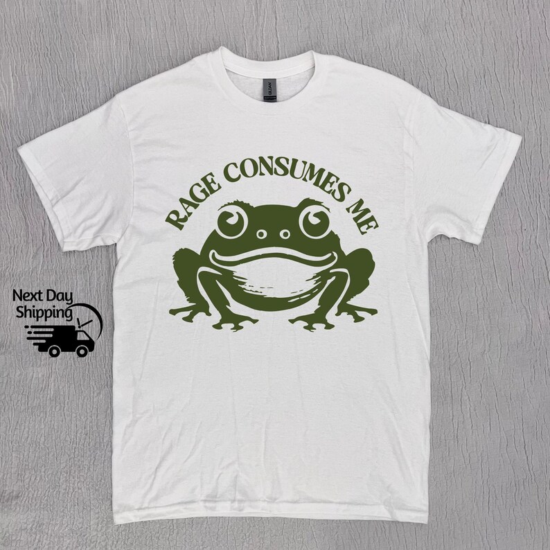 May include: White t-shirt with a green frog graphic and the text "Rage Consumes Me".