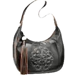 May include: Black leather shoulder bag with a decorative floral design on the front. The bag has a long strap, a brown tassel, and a silver-colored ring. The bag is made of leather and has a curved shape.