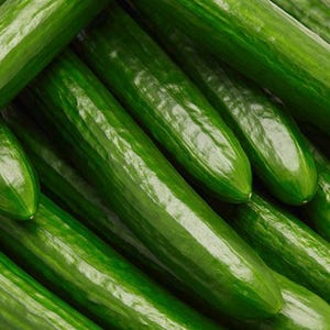 May include: A close-up shot of several fresh, green cucumbers. The cucumbers are arranged in a slightly overlapping pattern, showcasing their smooth, glossy skin and elongated shape. The vibrant green color suggests freshness.