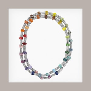 May include: A multi-strand necklace featuring a silver-toned chain with colorful, beaded accents. The beads are arranged in clusters of various colors, including red, orange, yellow, green, blue, and purple. The necklace is displayed against a white background.