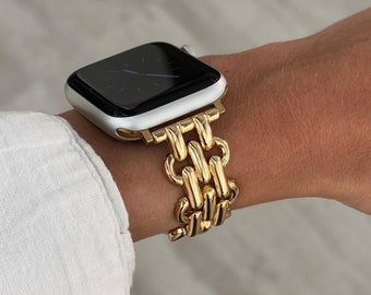 May include: A gold chain link Apple Watch band with a black Apple Watch face.