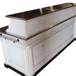 May include: White wooden bar counter with a stainless steel top. The counter has a decorative trim and a shelf underneath.