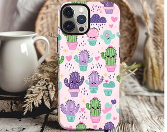 May include: A pink phone case with a cute cactus pattern. The case features green, purple, and pink cacti with smiling faces. There are also pink hearts and blue raindrops on the case.