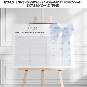 May include: A blue and white baby shower game sign with a watercolor bow on top. The sign says "Guess Baby Hudson's Birth Date" and has a calendar with the month of April and the beginning of May.