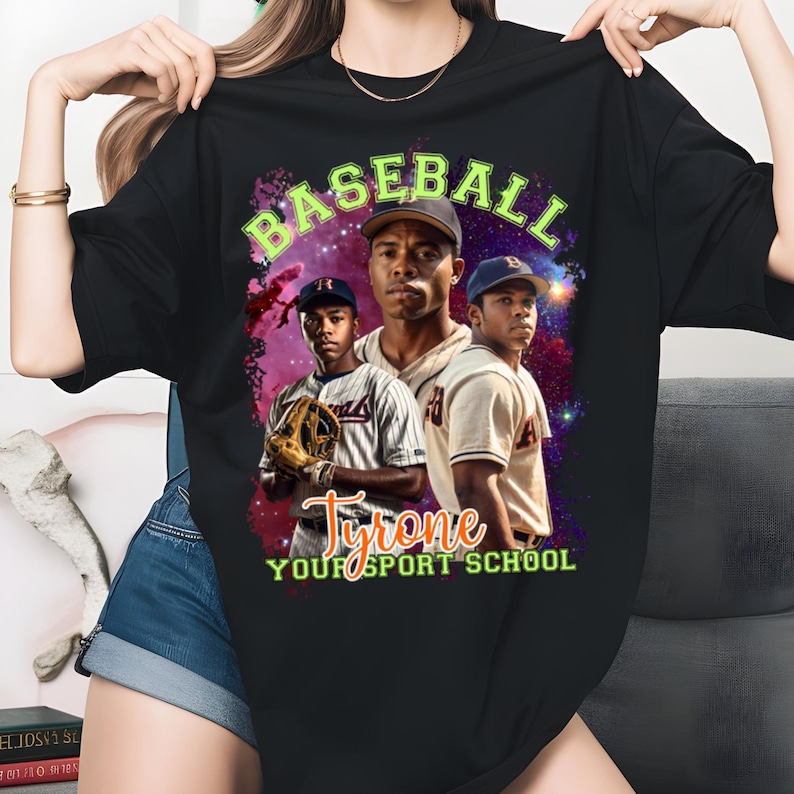 May include: Black t-shirt featuring a baseball-themed graphic. The design includes the word "BASEBALL" in green, and the name "Tyrone" with the text "YOUR SPORT SCHOOL". The graphic showcases three baseball players against a cosmic background.