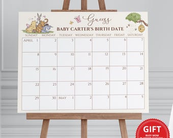 May include: A Winnie the Pooh themed baby shower game. Guests guess the baby's birth date on a calendar with Winnie the Pooh and friends characters. The calendar is on a wooden easel.