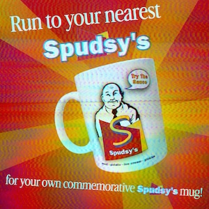 May include: White Spudsy's mug with a cartoon illustration of a man and the text "Try The Sauce." The mug also features the text "Spudsy's" and the words "meat, potato, ice cream, pickles."