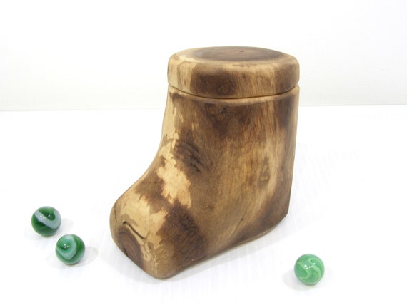 A hand-turned Black Walnut branch box — the wood grain IS the design, and it doubles as a guitar pick box, pet urn, or keepsake; raw material beauty with real utility.