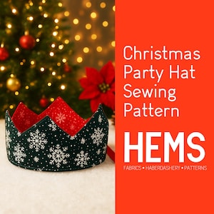 May include: A Christmas party hat sewing pattern. The hat is a crown shape, with a dark green exterior decorated with white snowflakes and a red interior. The text "Christmas Party Hat Sewing Pattern" is on the right.