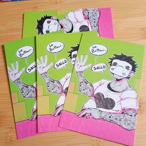 May include: Four art prints featuring a cartoon character with a mask and tattoos. The character is wearing a white shirt and waving. The prints have a green background with pink and yellow accents, and the text "Le Batteur" and "Salut!"
