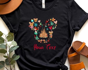 May include: Black t-shirt with a Christmas-themed Mickey Mouse head design featuring a castle, ornaments, and the text "Your Text".