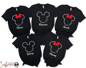 May include: Five black t-shirts with a white Mickey Mouse silhouette and the year 2025. Each shirt has a different word printed below the silhouette: Sister, Brother, Auntie, Daddy, Mommy.