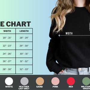May include: Size chart for a sweatshirt with measurements in inches for width and length. The chart shows sizes S, M, L, XL, and 2XL. The sweatshirt is available in 10 colors: black, white, heather light grey, sand, pink, red, military green.