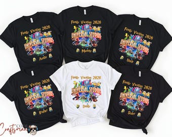 May include: A collection of black and white t-shirts with the text "Family Vacation 2026" and "Universal Studios". Each shirt has a different family member's title, such as "Auntie", "Mommy", "Uncle", "Brother", "Daddy", and "Sister".