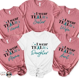 May include: Six t-shirts in various shades of pink and white with teal ribbon designs and the text "I wear teal for my..." followed by a word like "sister", "friend", "wife", "mama", "daughter", or "aunt".